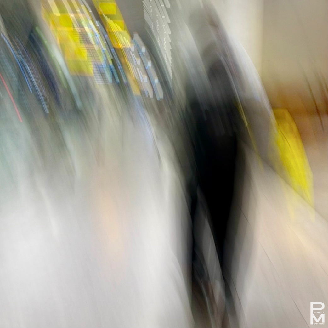 ICM digital photograph of a blurred figure walking in a colourfully lit hallway