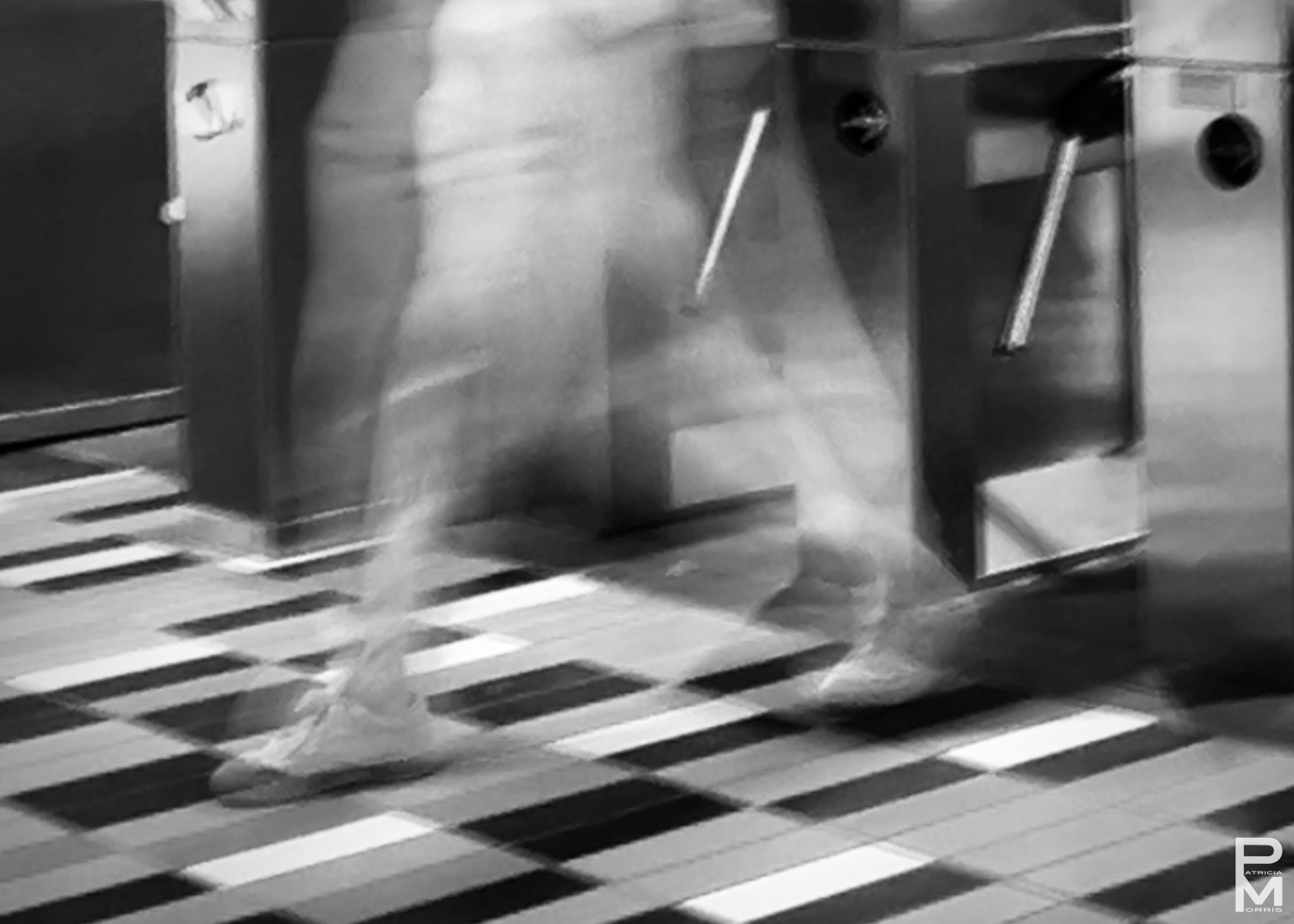 ICM digital photograph of blurred legs passing through a metro turnstile, In Transit
