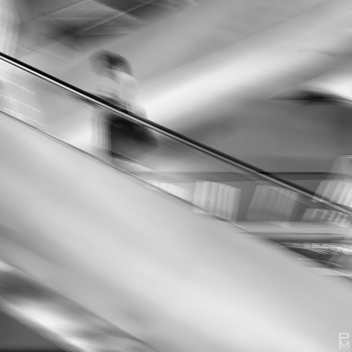 ICM digital photograph of a woman on an escalator, In Transit