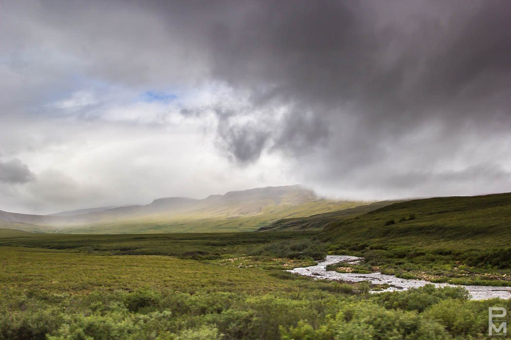 Landscape vista in dramatic weather seen from the Dempster Highway near Tombstone Territorial Park in Yukon Territories