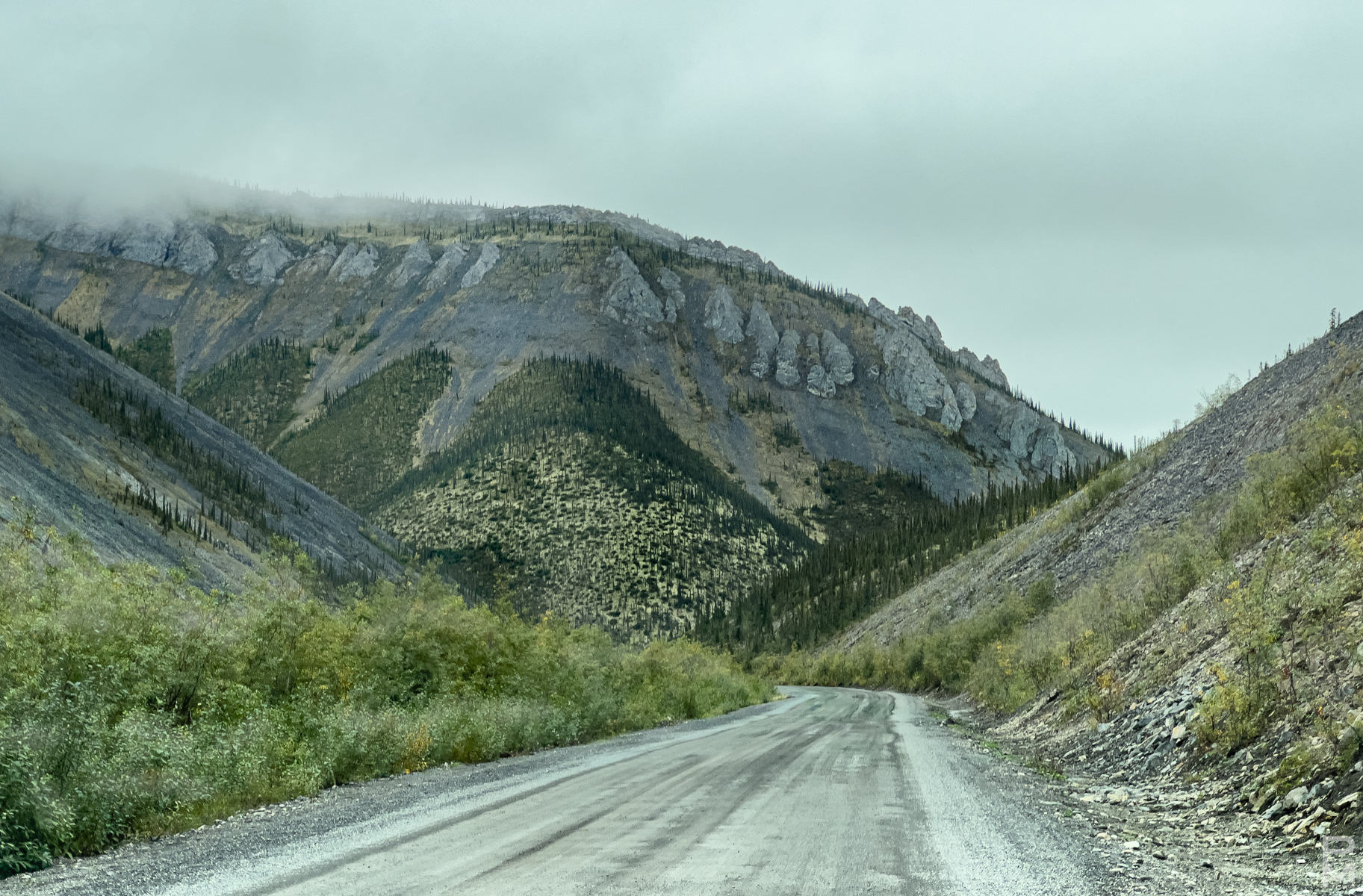 Landscape, digital photograph, view of road heading into unique mountain structure on the Dempster Highway in the Northwest Territories
