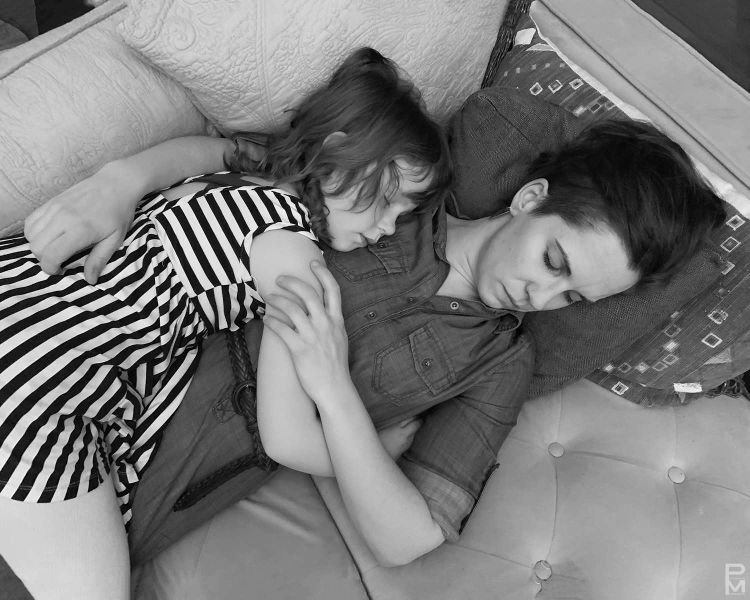 Digital photograph of mother and daughter resting, taken from above.