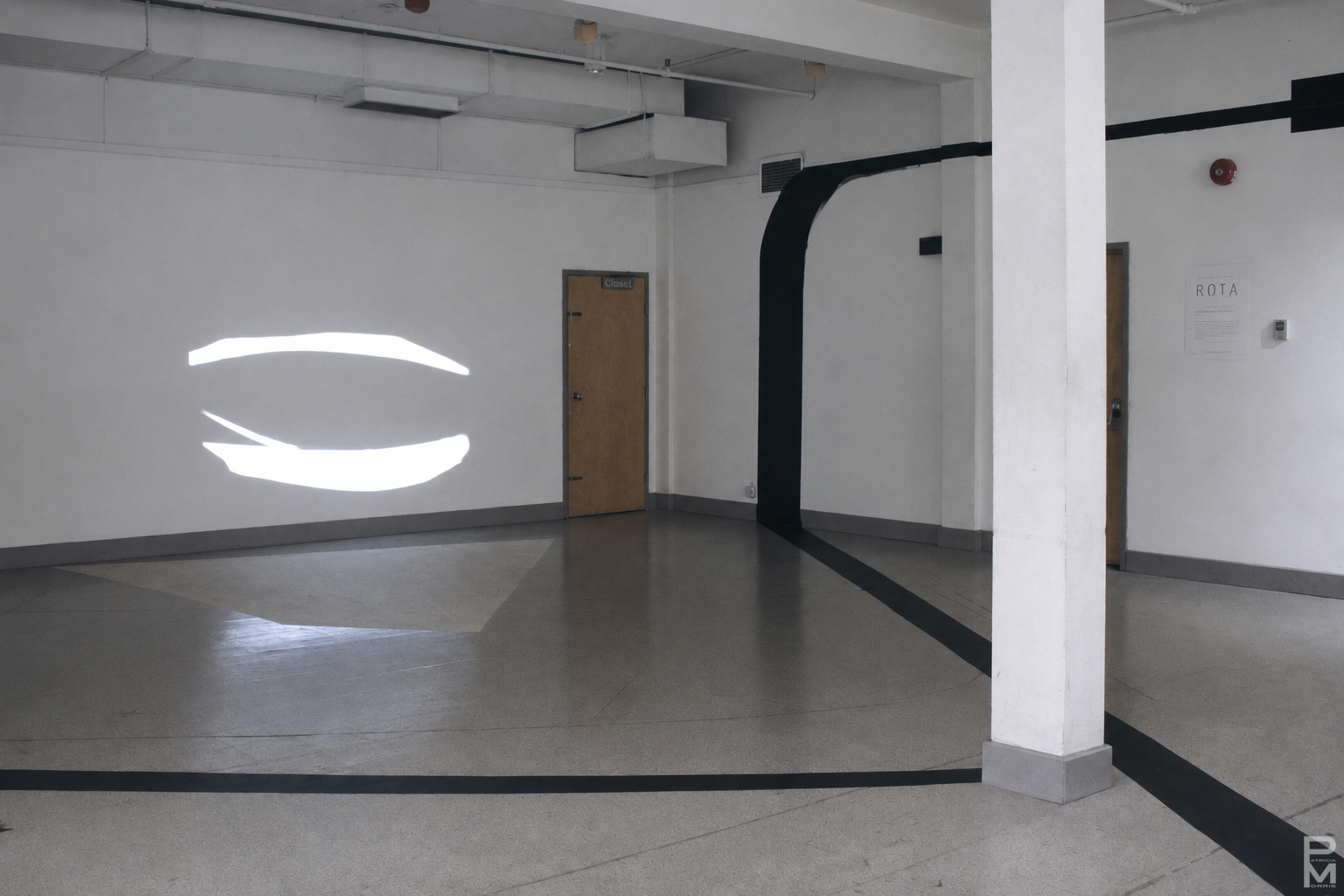 Black and white view of ART PLAY III installation with painting on the gallery walls, floor and ceiling and geometric light projections across the gallery floor.