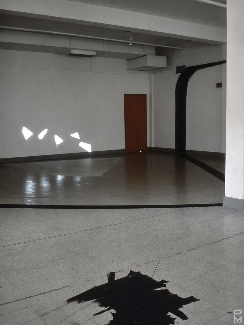 Black and white view of ART PLAY III installation with painting on the gallery walls, floor and ceiling and geometric light projections across the gallery floor.