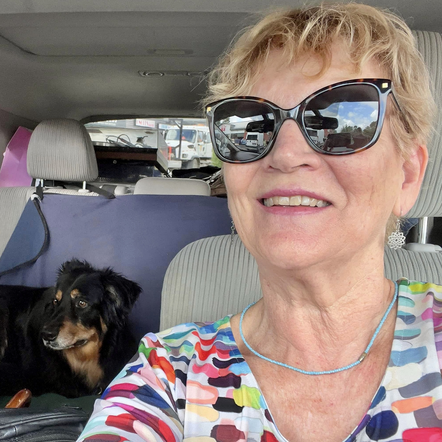 Image of Patricia Morris and her dog, Dali, in a car