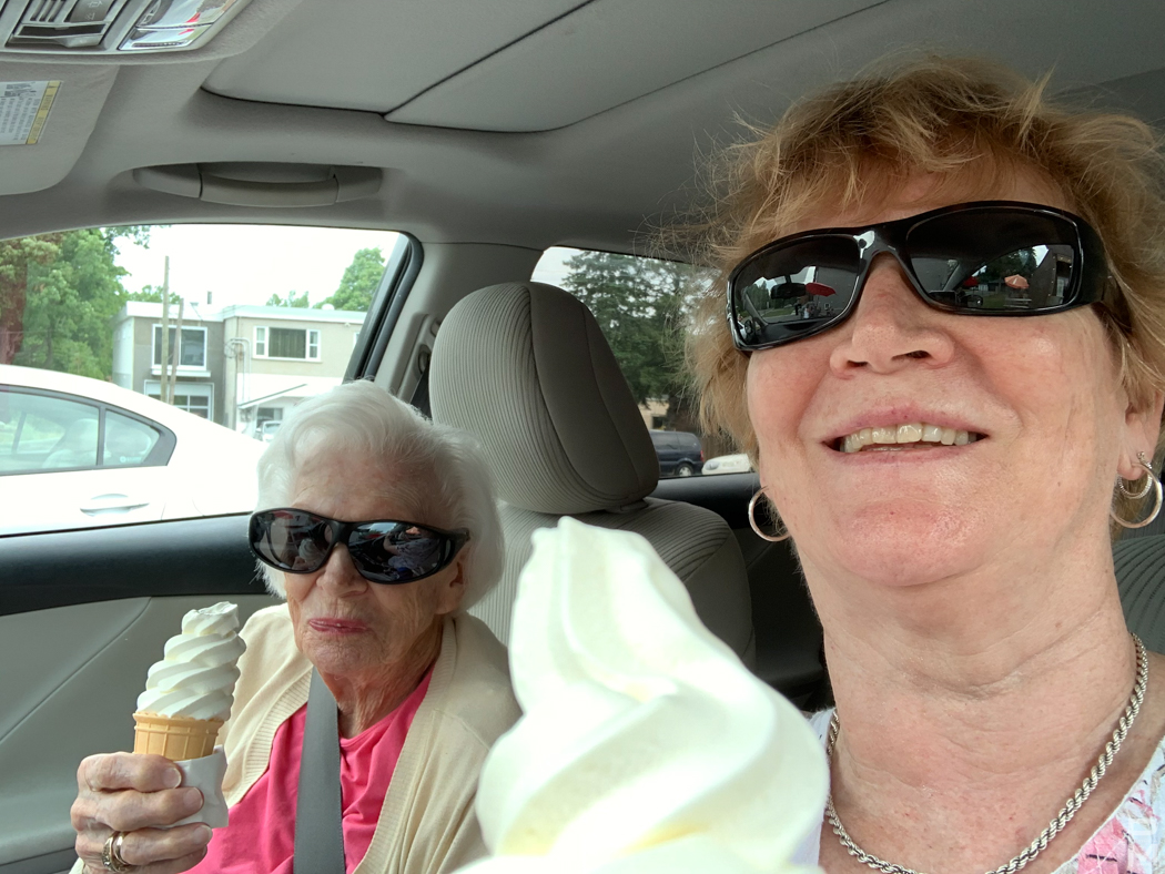 Two people in a car holding soft-serve ice cream cones