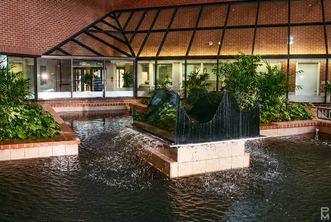 Sculpture made of stacked pieces of glass depicting a wave installed in the atrium of Sackville Memorial Hospital