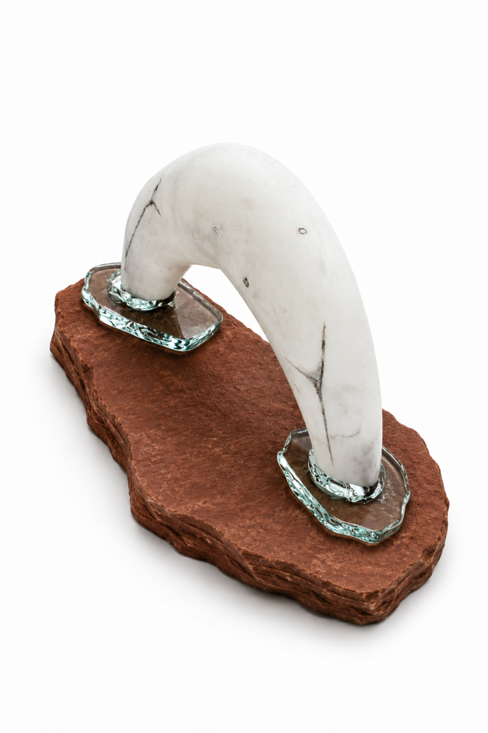 Sculpture made of alabaster and glass, resembling an arched form diving into a base.