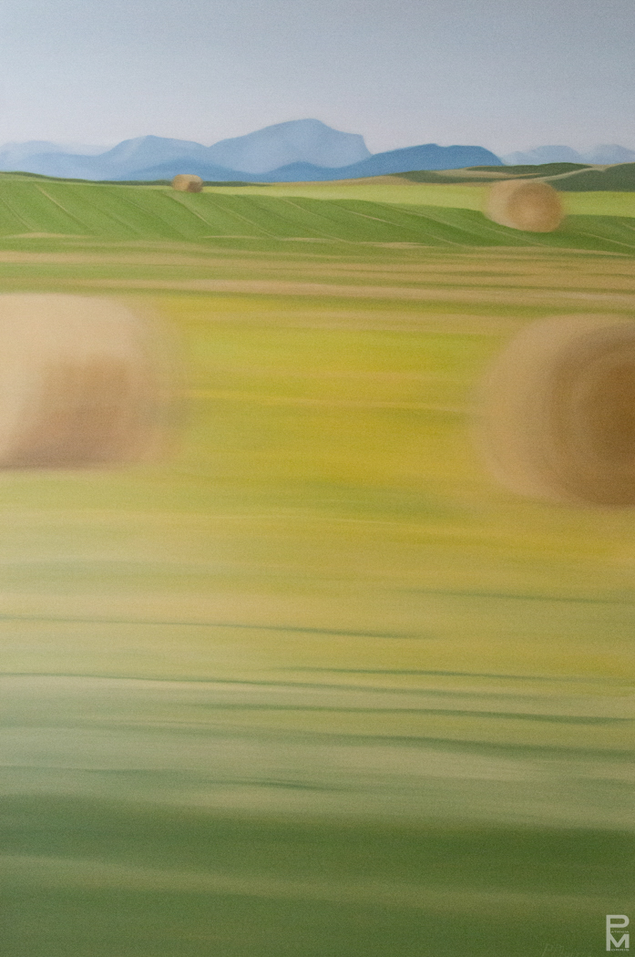 Oil painting with the Rocky mountains in the distance and hay fields with round bales in the mid and foregrounds