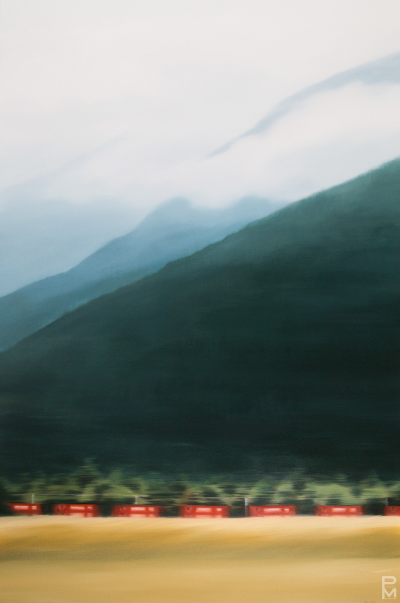 Oil painting of a mountain scene that includes a Canadian Tire train passing by